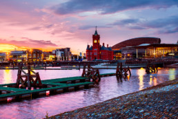 Waterfront at night in Cardiff, UK. Sunset colorful sky with Wales Millennium Center
